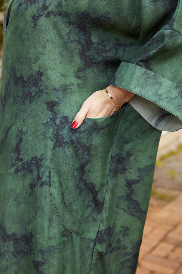 Close up view of sleeve and pocket of Dessous Loungewear Bianca caftan midi dress in green and navy print sustainable Lyocell fabric.