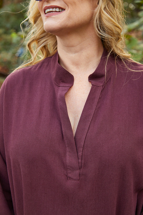Close up of neckline of Dessous Loungewear Bianca caftan in plum colored sustainable Lyocell fabric.
