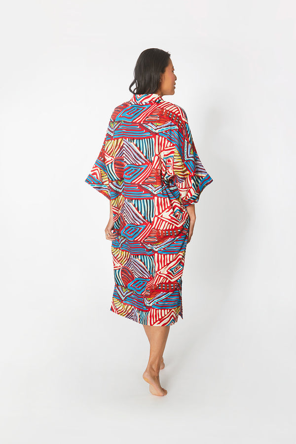 Back view of woman wearing Dessous Loungewear's Bianca caftan in a cotton geometric print.