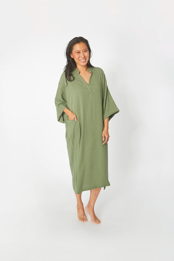 Beautiful Asian woman wearing Dessous Loungewear Bianca Caftan in moss green sustainable Lyocell fabric.