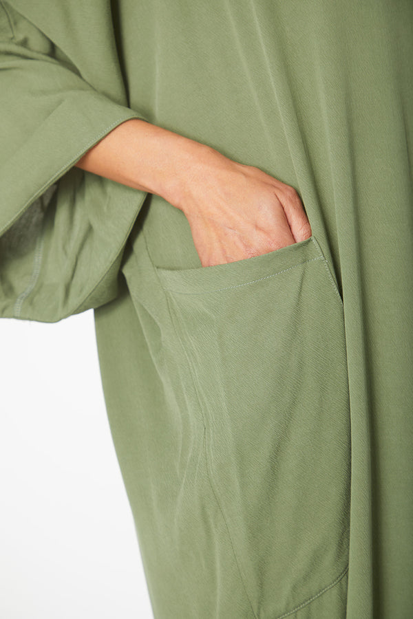 Close up view of pocket and sleeve of Dessous Loungewear Bianca Caftan in moss green sustainable Lyocell fabric.
