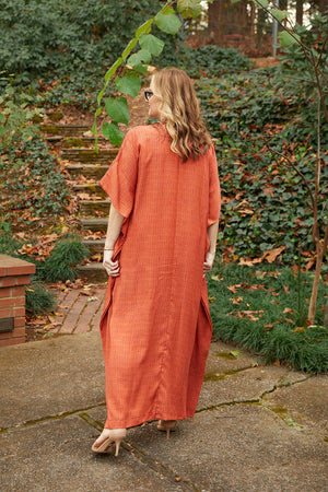 Back view of woman wearing Dessous Loungewear's Grace caftan. Grace is our classic, flowy maxi-length caftan design with an oversized, body skimming silhouette that makes it a versatile choice for lounging at home, as a cover up at the beach, or even dressed up with jewelry and strappy sandals for a formal event. The eco-friendly fabric is 100% Tencel™ Lyocell which is sustainable, biodegradable and compostable.